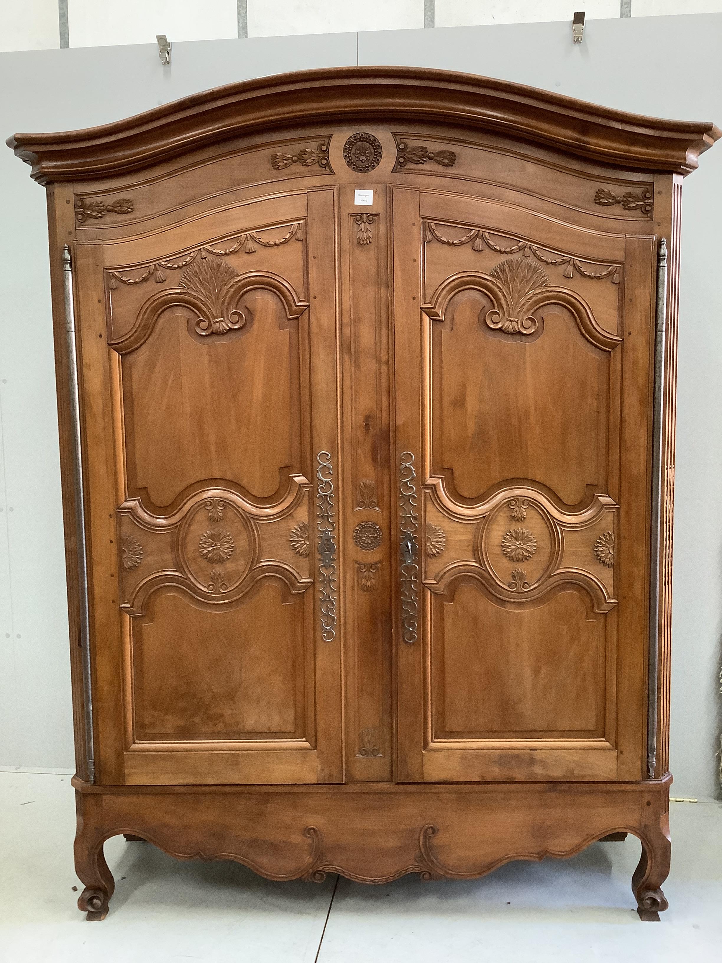 A Louis XV style carved walnut two door armoire, width 150cm, depth 50cm, height 200cm